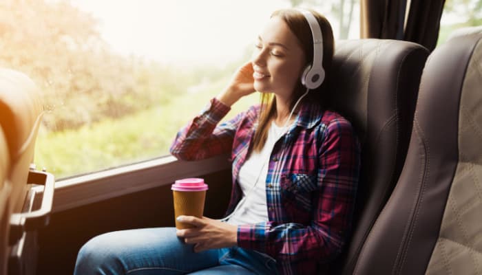 a passenger listening to music on a charter bus